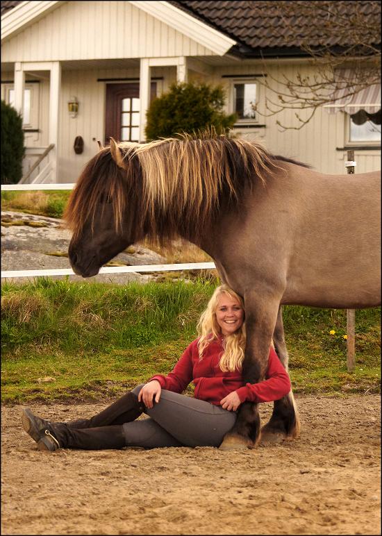 Camilla sitting happily with horse